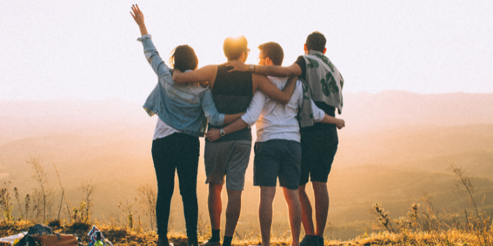 4 Menschen, Arm im arm mit Blick in die Ferne